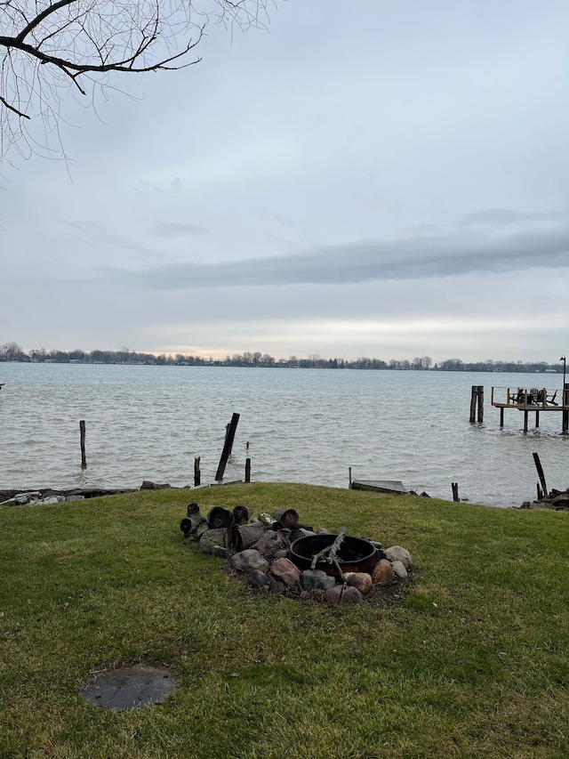 exterior space featuring a dock and an outdoor fire pit