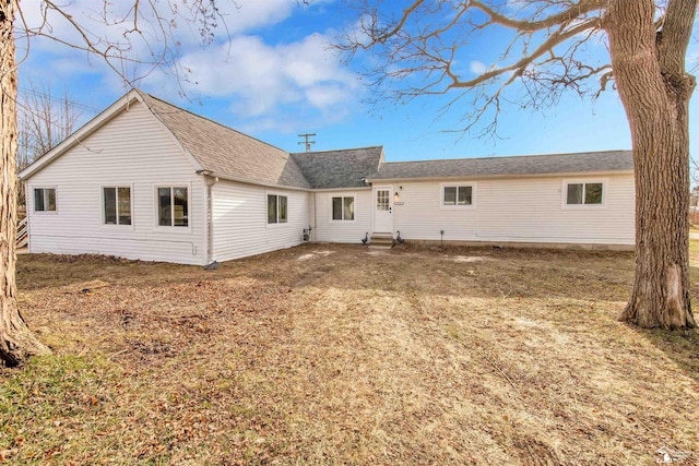 rear view of property with a yard