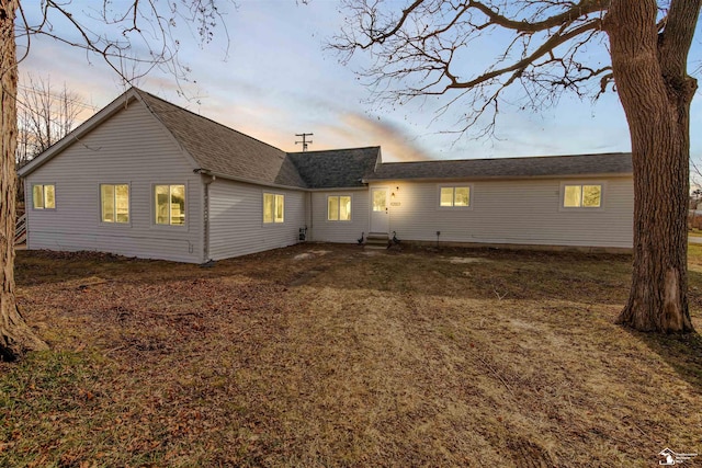 view of back house at dusk