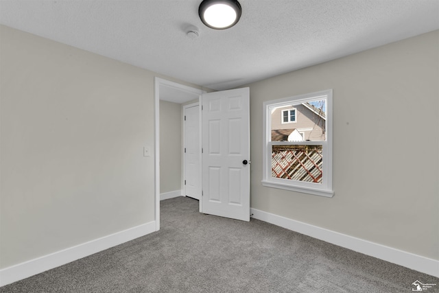 unfurnished bedroom featuring carpet flooring and a textured ceiling