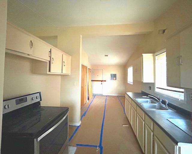 kitchen with stainless steel electric stove, lofted ceiling, and sink