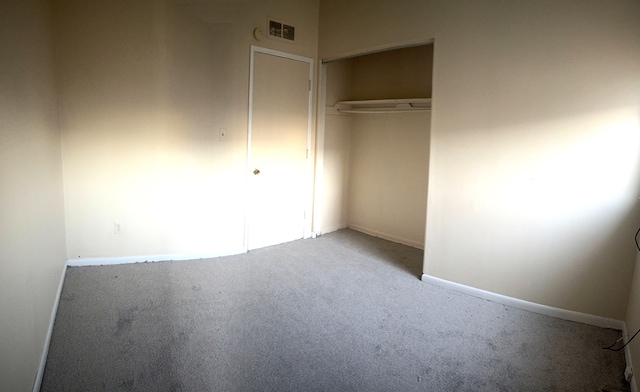 unfurnished bedroom with carpet flooring and a closet