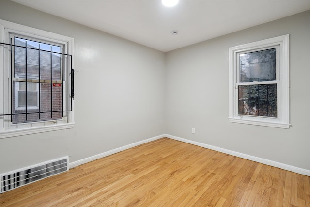 unfurnished room with light hardwood / wood-style floors