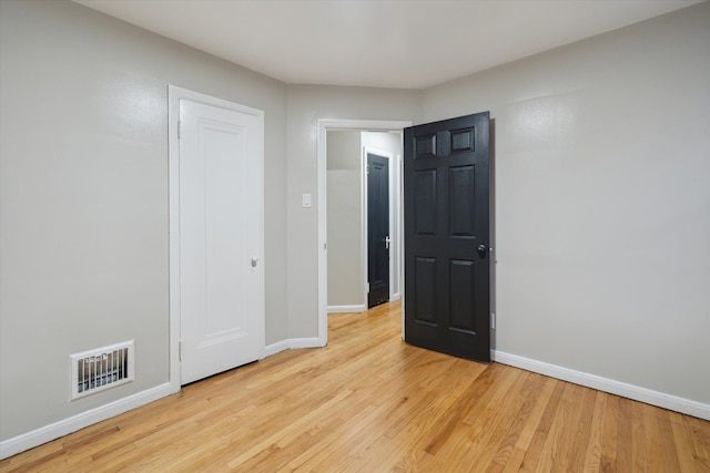 unfurnished bedroom with light wood-type flooring