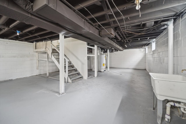 basement featuring water heater and sink