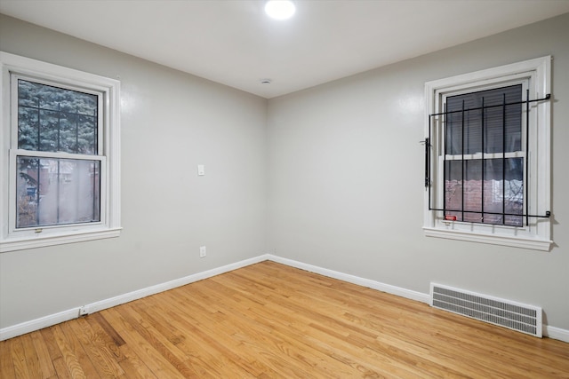 spare room with light hardwood / wood-style flooring