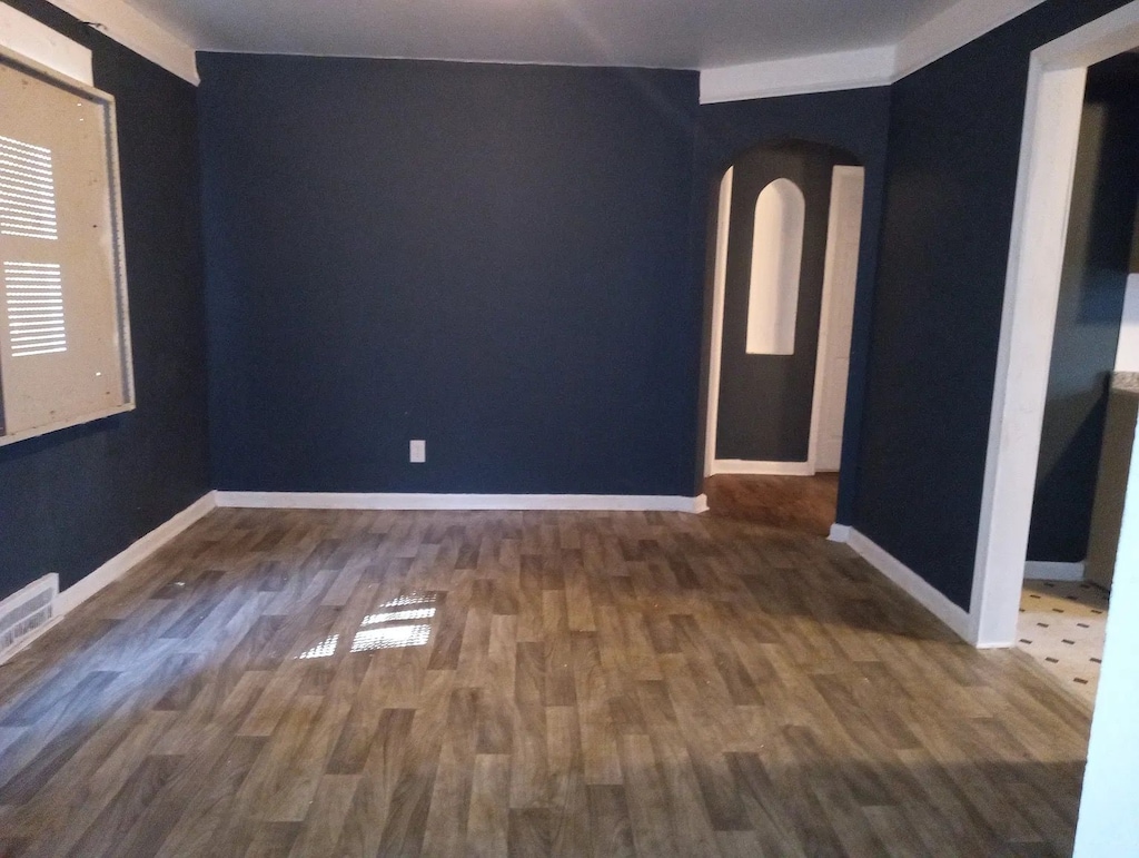 spare room featuring dark hardwood / wood-style flooring