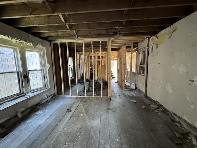 misc room with a baseboard heating unit and hardwood / wood-style floors