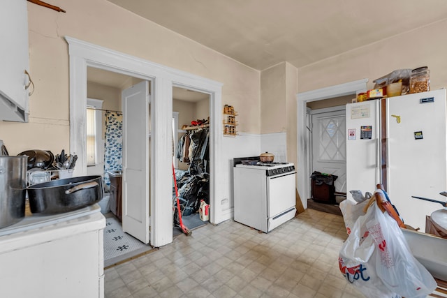 kitchen with white cabinets and white appliances