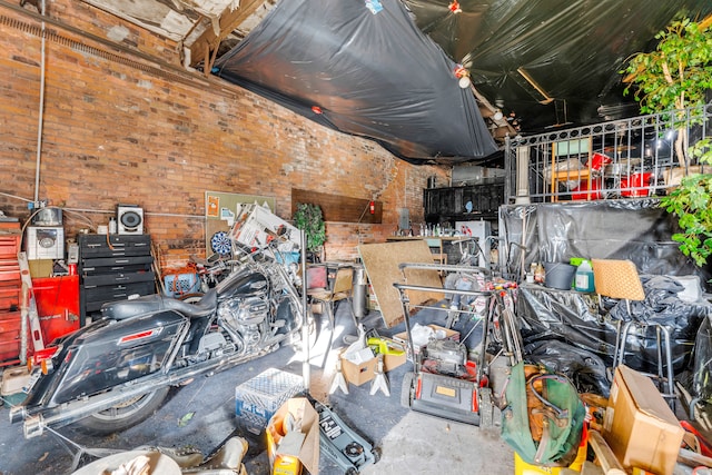 miscellaneous room with concrete flooring and brick wall