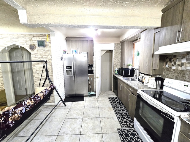 kitchen featuring sink, stainless steel refrigerator with ice dispenser, white electric stove, a textured ceiling, and light tile patterned floors