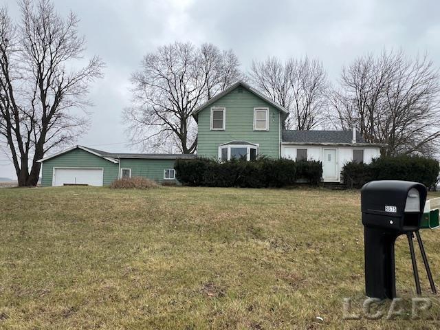 view of front of home featuring a front lawn and a garage