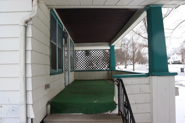 snowy yard with a porch