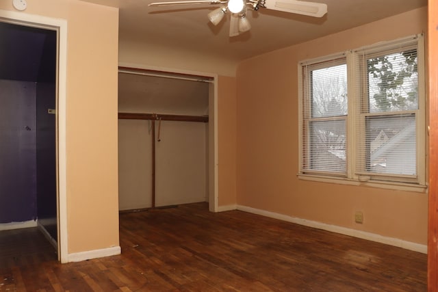 unfurnished bedroom with dark hardwood / wood-style floors, a closet, and ceiling fan