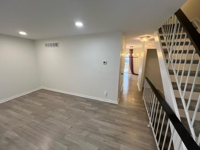1622 Brentwood Dr, Troy, MI 48098 - basement featuring dark wood finished floors, baseboards, stairway, recessed lighting, and a chandelier