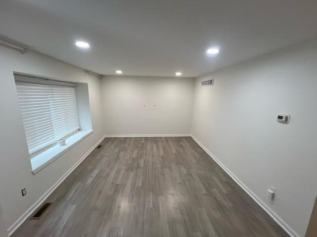 unfurnished room featuring dark wood-type flooring