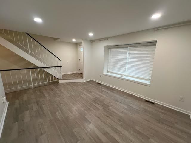 unfurnished living room featuring dark hardwood / wood-style floors