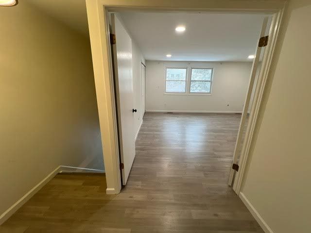 hallway with wood-type flooring