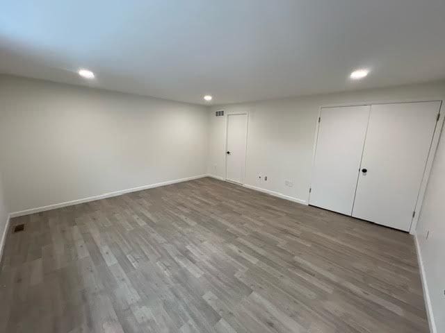 basement with hardwood / wood-style flooring