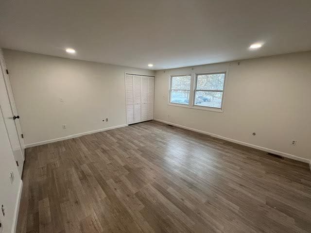 1622 Brentwood Dr, Troy, MI 48098 - unfurnished bedroom with dark wood-type flooring, recessed lighting, baseboards, and a closet