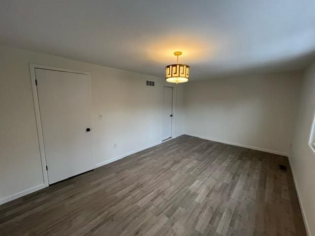 spare room with dark wood-type flooring