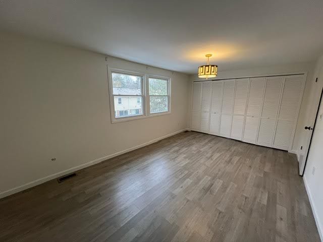 1622 Brentwood Dr, Troy, MI 48098 - unfurnished bedroom featuring wood finished floors and baseboards