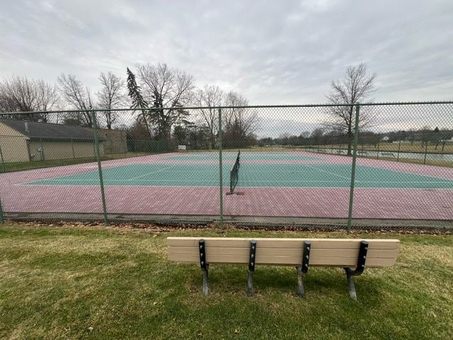 view of sport court featuring a yard