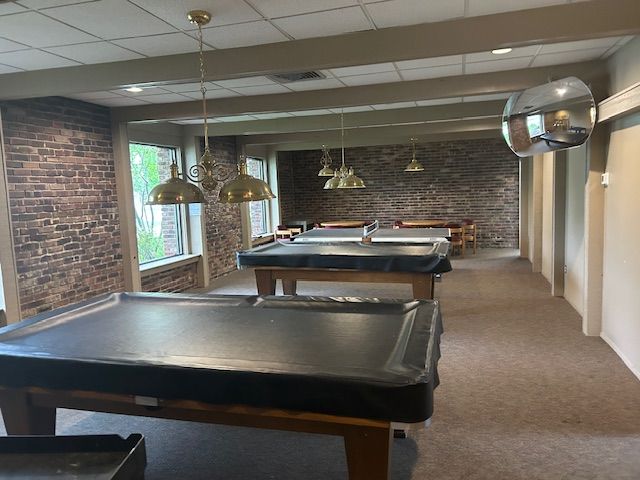 1622 Brentwood Dr, Troy, MI 48098 - recreation room with brick wall, pool table, carpet, and a paneled ceiling