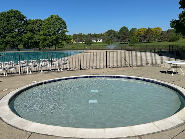 1622 Brentwood Dr, Troy, MI 48098 - community pool with fence, view of wooded area, and a patio