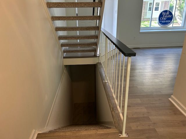 1622 Brentwood Dr, Troy, MI 48098 - stairway with wood finished floors and baseboards