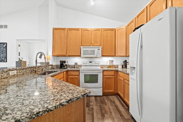 kitchen with dark hardwood / wood-style flooring, lofted ceiling, sink, and white appliances