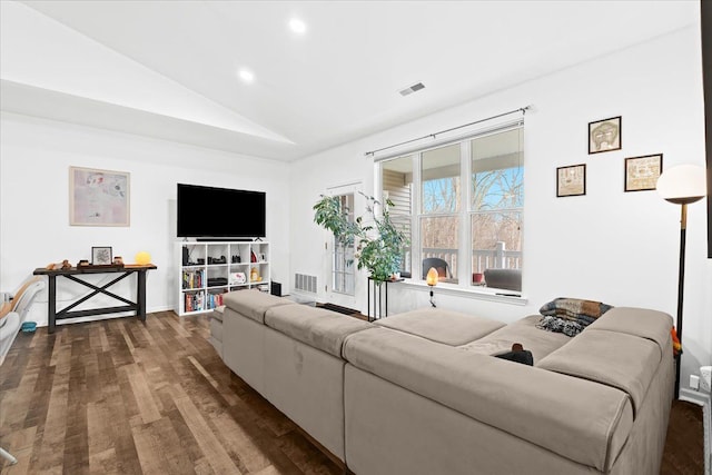 living room with dark hardwood / wood-style floors and lofted ceiling