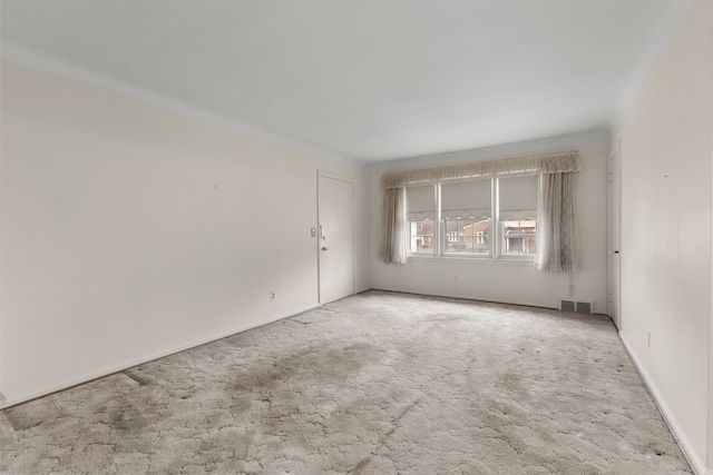 carpeted empty room with crown molding