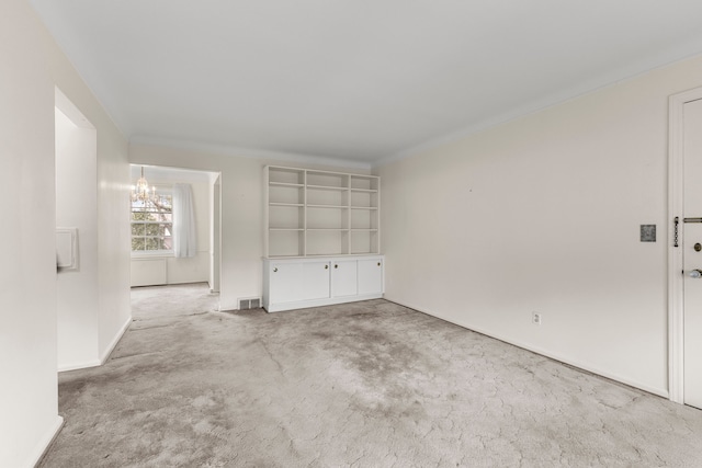 unfurnished room featuring light carpet and an inviting chandelier