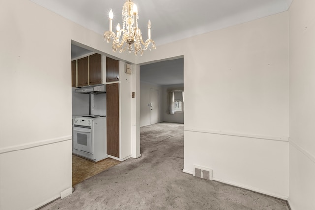 interior space featuring light carpet and a chandelier