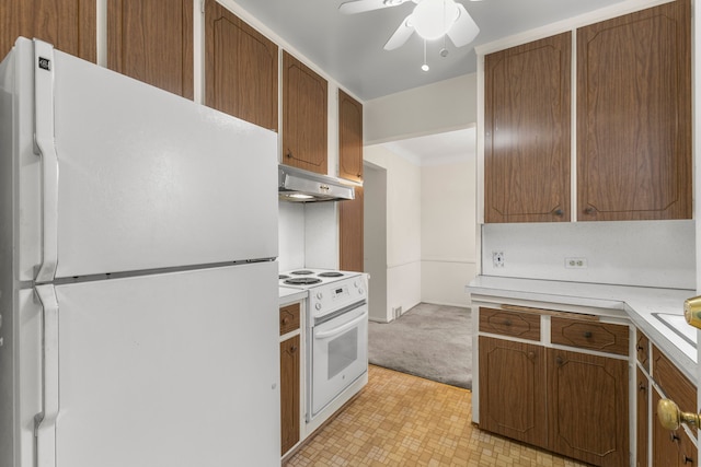 kitchen with light carpet, white appliances, and ceiling fan