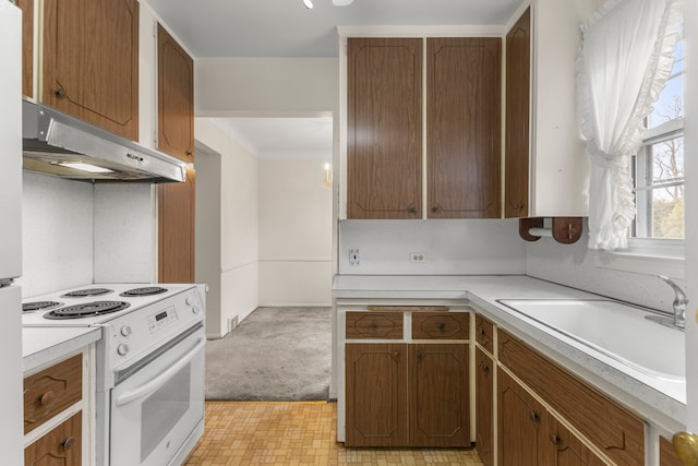 kitchen featuring white range with electric stovetop and sink