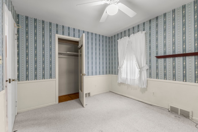 unfurnished bedroom with a closet, ceiling fan, and light colored carpet