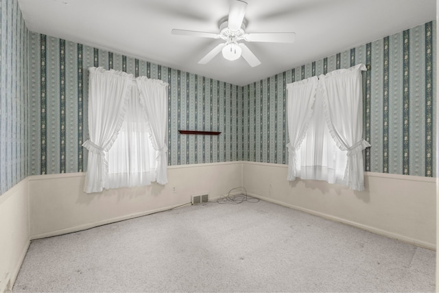 spare room with ceiling fan and carpet floors