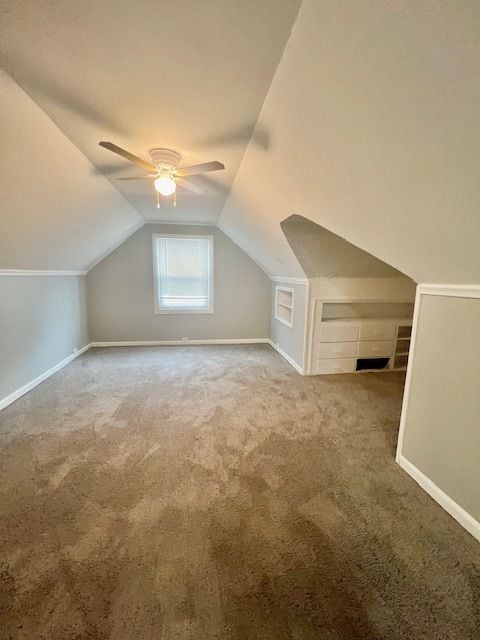 bonus room with ceiling fan, lofted ceiling, and carpet floors