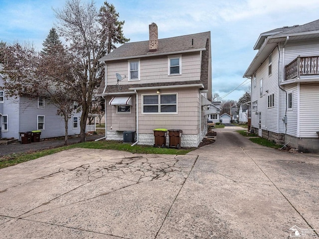 back of property featuring central air condition unit