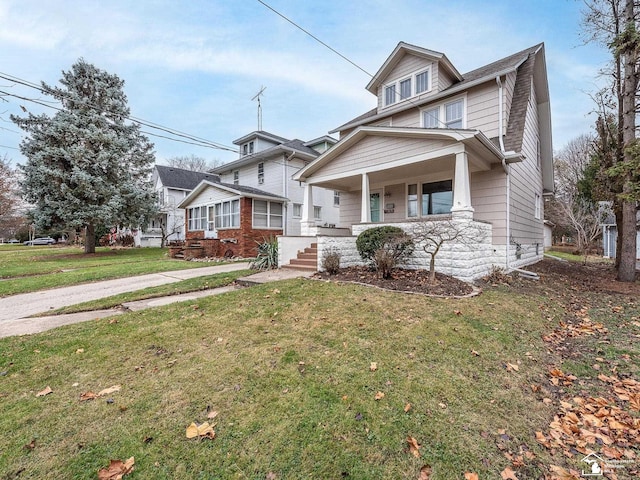 view of front of home with covered porch and a front yard