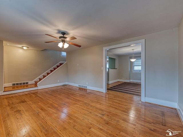 spare room with wood-type flooring and ceiling fan