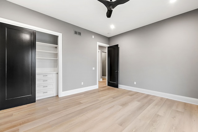 unfurnished bedroom featuring ceiling fan, a closet, and light wood-type flooring