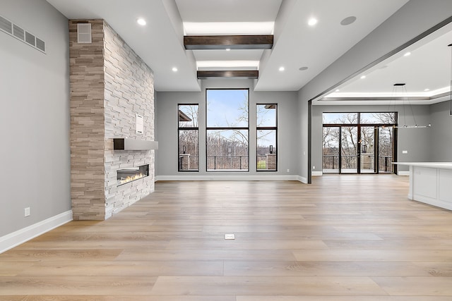 unfurnished living room with a fireplace and light wood-type flooring