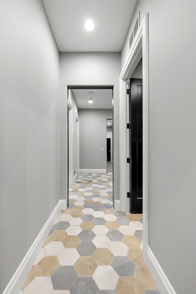 corridor with light tile patterned floors