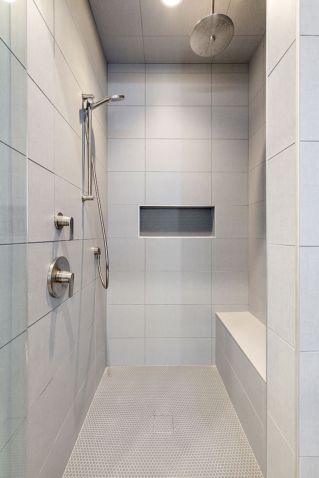 bathroom with a tile shower