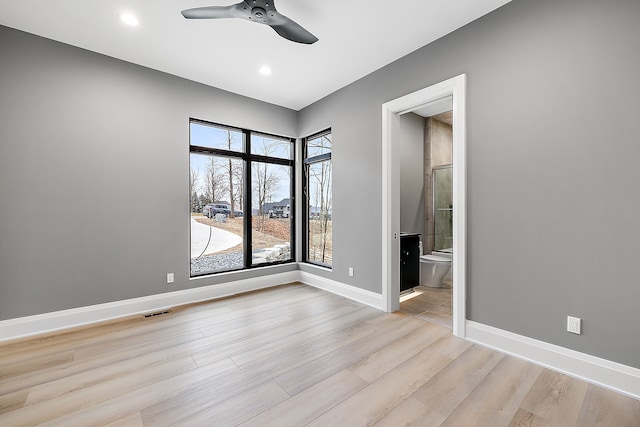 unfurnished room with ceiling fan and light hardwood / wood-style floors