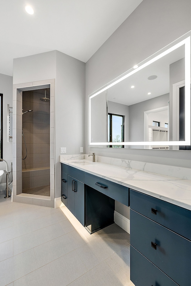 bathroom featuring tile patterned floors, vanity, and tiled shower