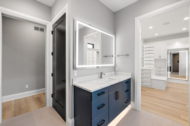 bathroom with tile patterned flooring and vanity